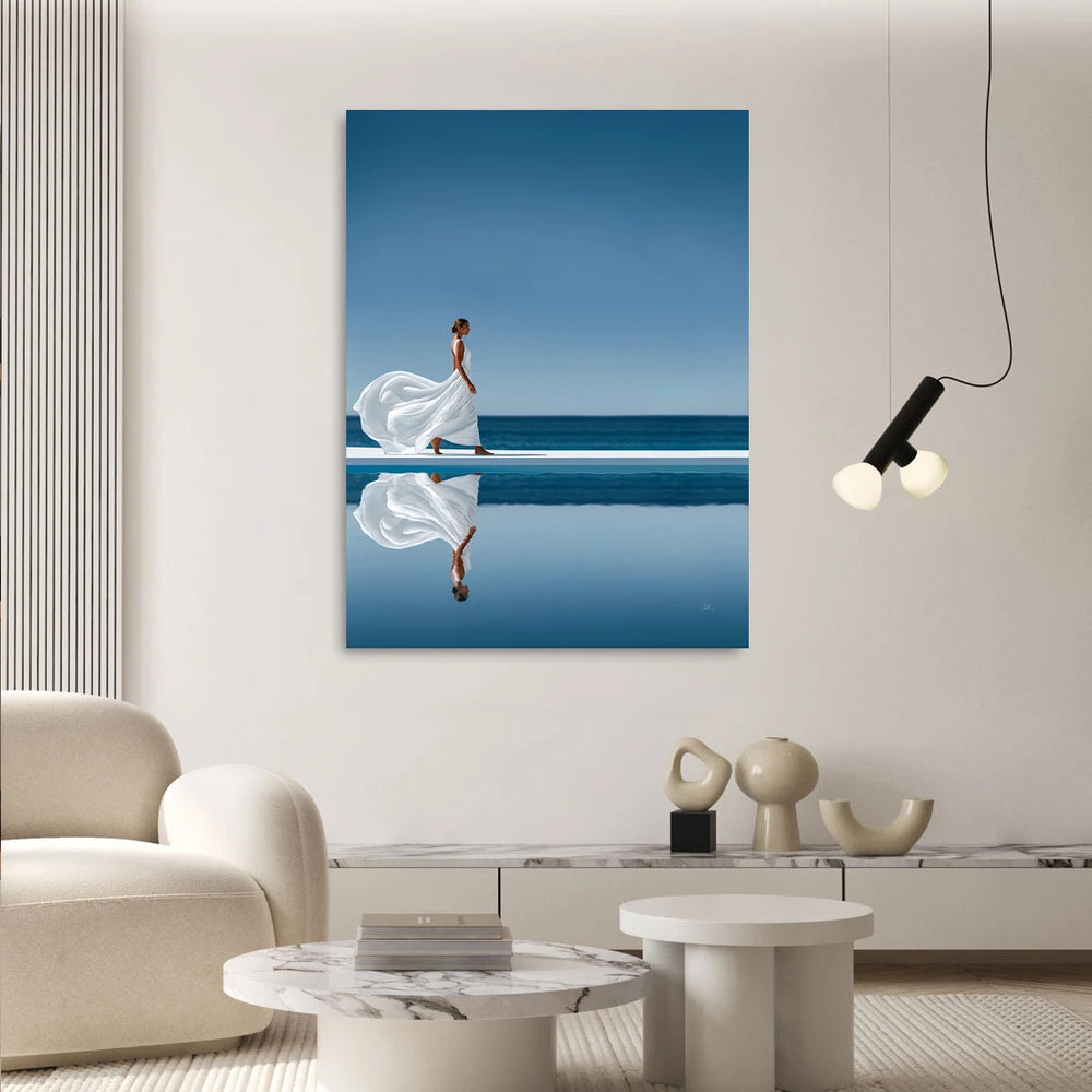 Symmetrical coastal scene in cool blues with a crisp white dress reflected over water.