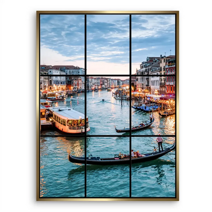 Gondolas and city lights reflect warmly on the water