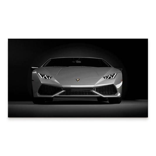 Front-on grayscale Lamborghini Huracan canvas print with a dark background and bright LED headlights.