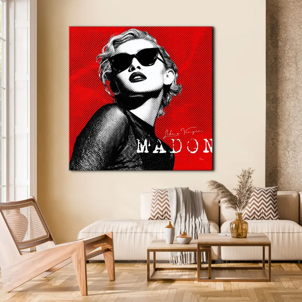 Close-up portrait of Madonna-inspired figure wearing dark sunglasses on red canvas