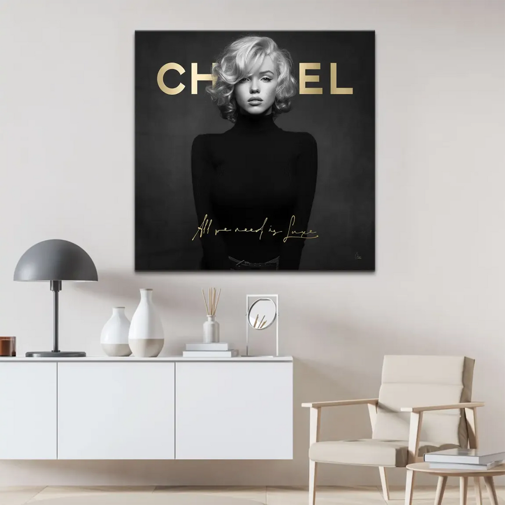 Centered Marilyn Monroe art print in a black turtleneck featuring bold gold lettering