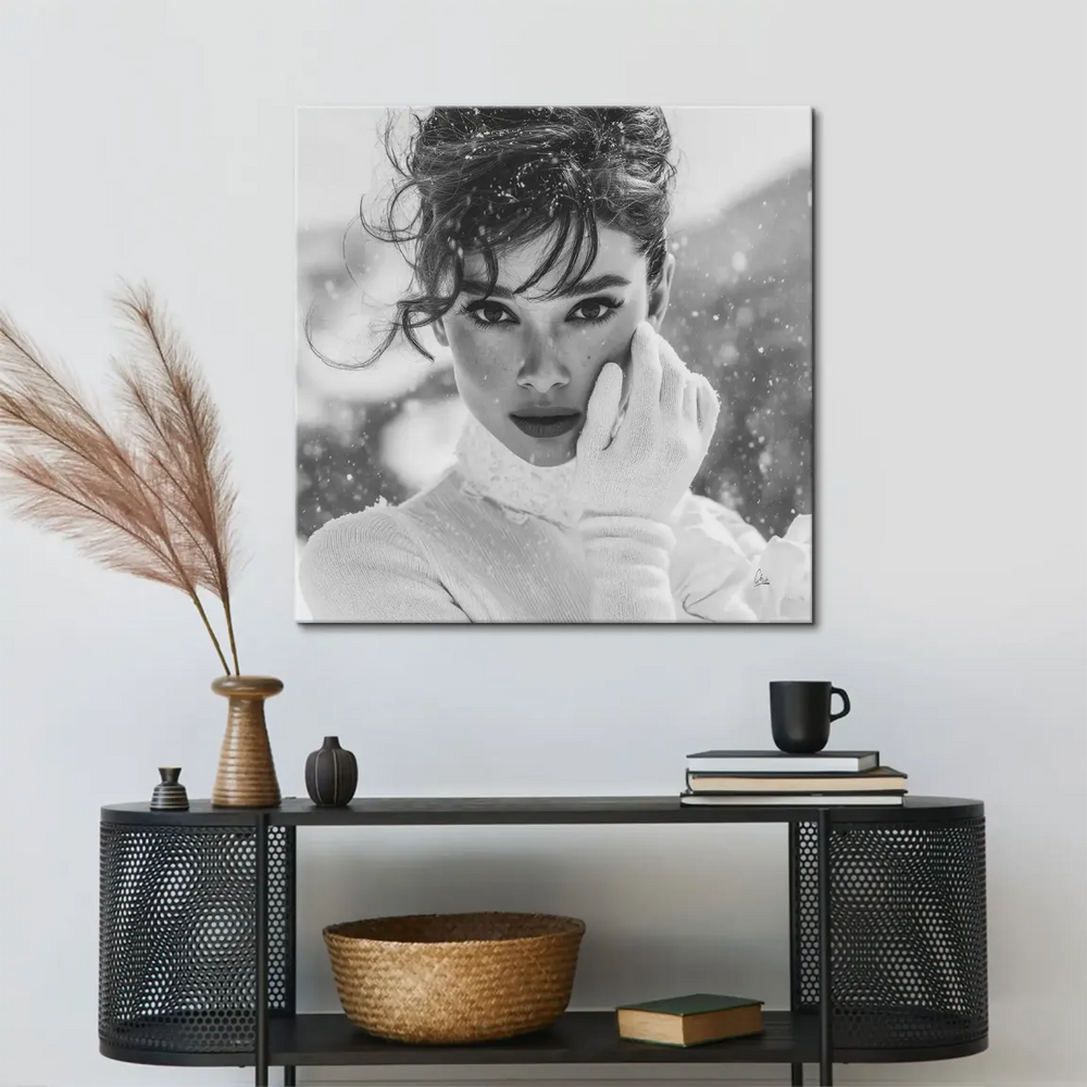 Close-up of Audrey Hepburn's face with snowflakes on a black-and-white canvas