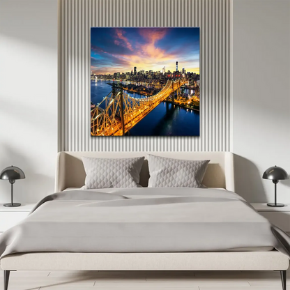 An aerial view of New York City skyline at sunset featuring the Queensboro Bridge