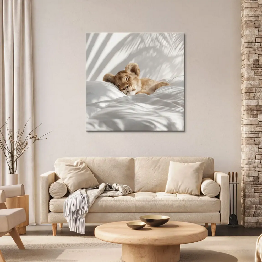 Lion cub asleep against white and cream tones with soft shadows