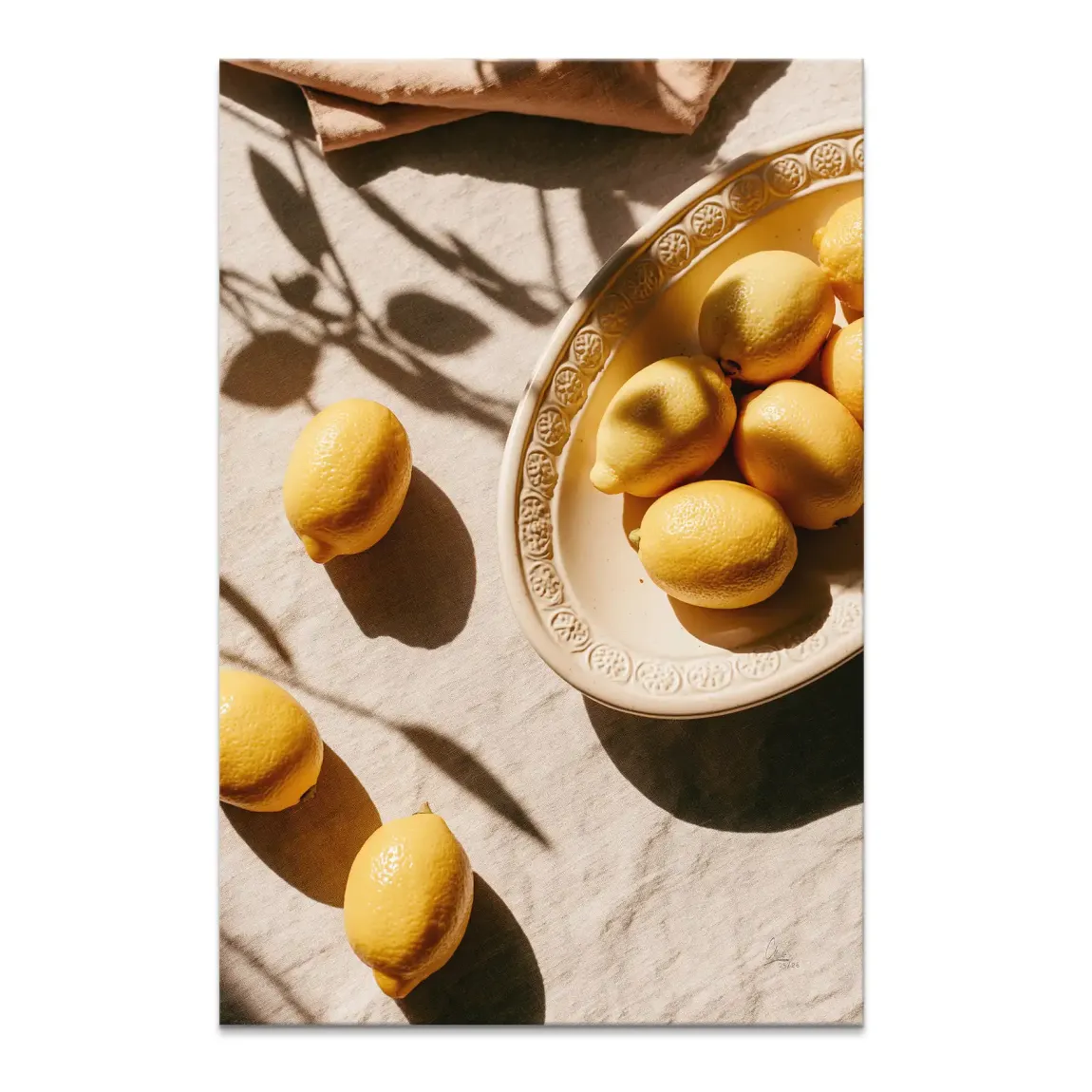 Golden lemons on a decorative off-white dish on a beige textured tablecloth, sunlit canvas still life.