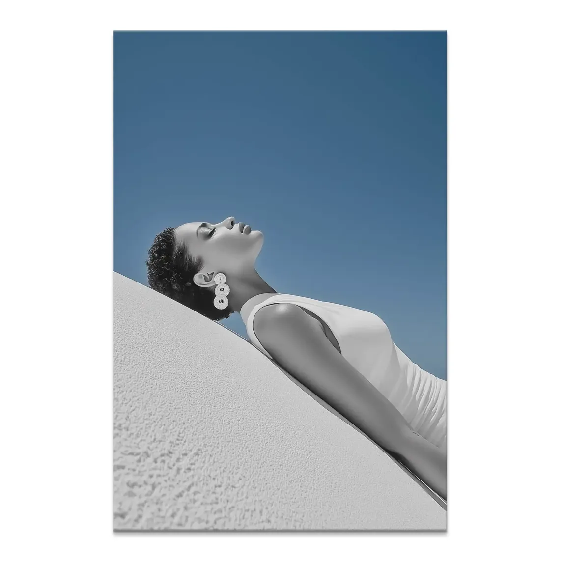 Sun Girl Canvas Picture: woman leaning against a textured white wall, bathed in sunlight.