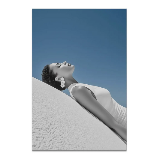 Sun Girl Canvas Picture: woman leaning against a textured white wall, bathed in sunlight.