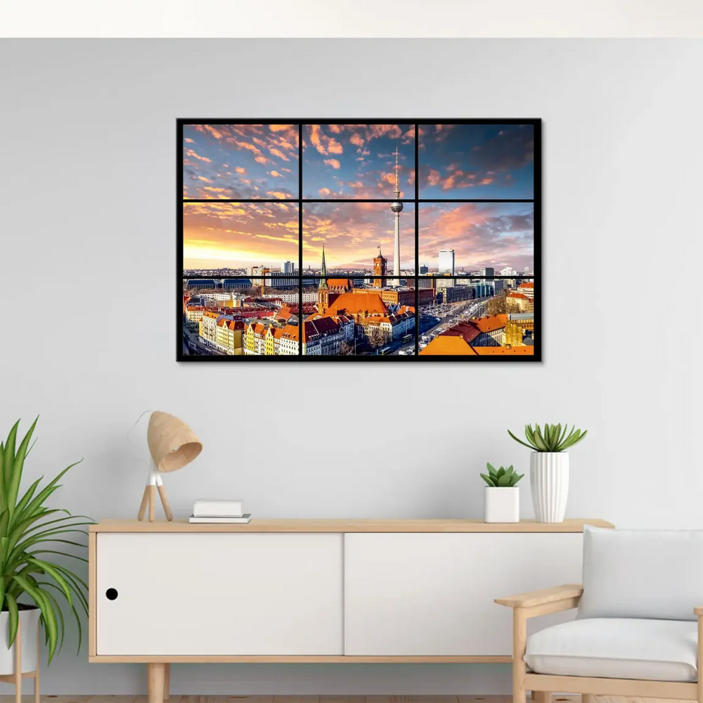 Panoramic Berlin cityscape with warm orange, pink, and yellow sky