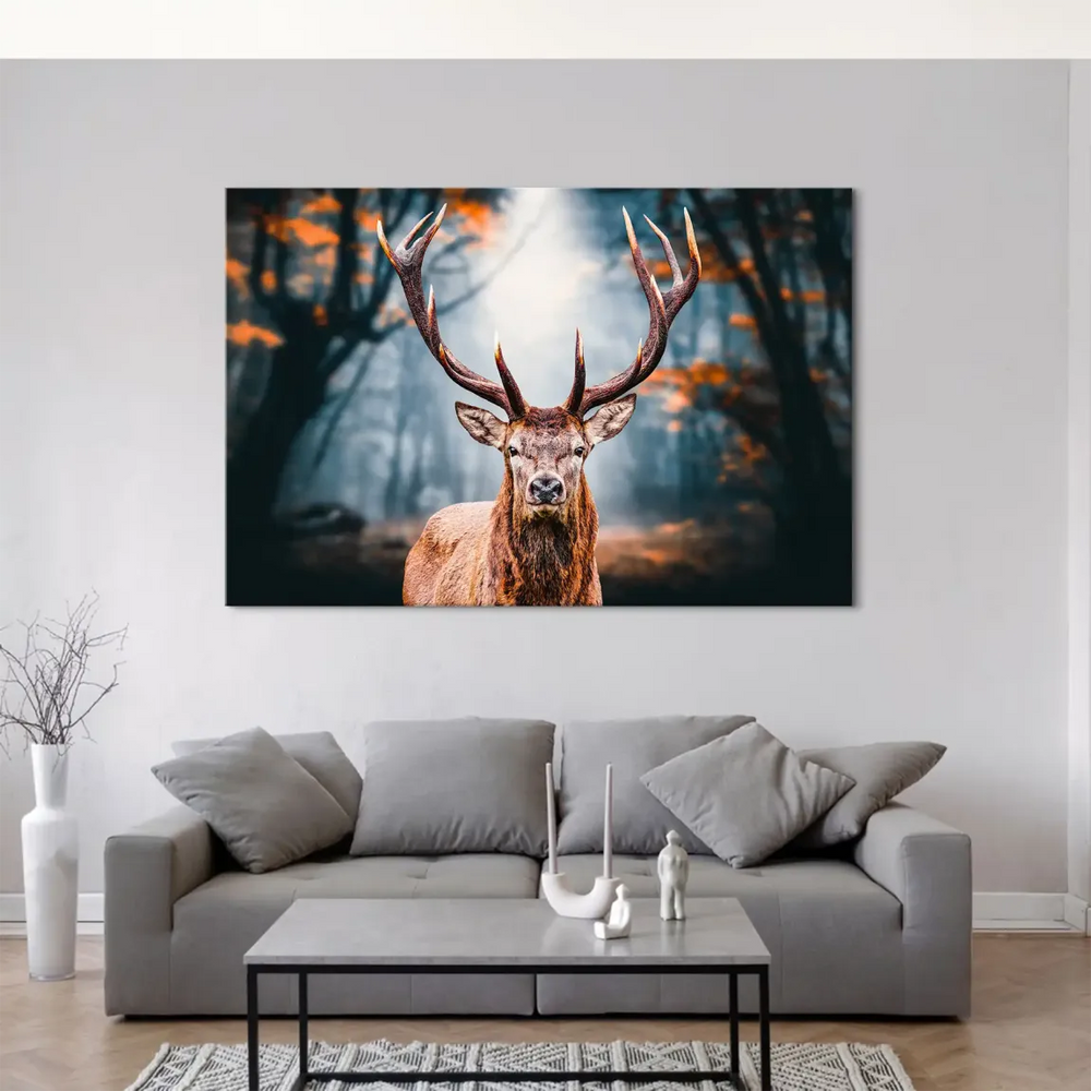 Deer bathed in warm browns and oranges among autumn leaves with a cool blue-grey forest background.
