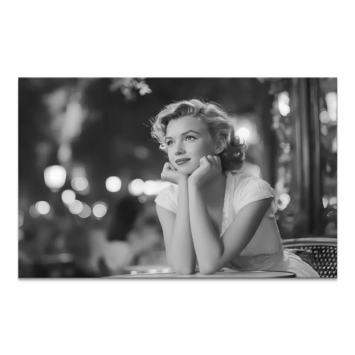 Marilyn Monroe in a contemplative pose at an outdoor cafe in a black-and-white canvas wall art