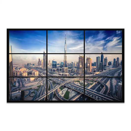Panoramic aerial view of Dubai skyline at sunset with central Burj Khalifa and blue-gold tones