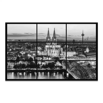 Cologne Cathedral illuminated at dusk in a black-and-white cityscape
