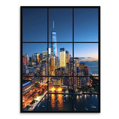Nighttime New York City skyline with One World Trade Center lit up among a sea of illuminated buildings.