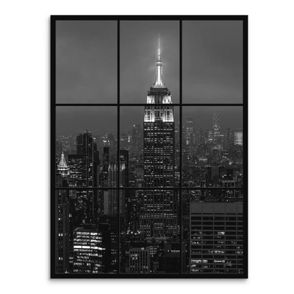Nighttime New York City skyline featuring the Empire State Building as seen through a gridded window in monochrome.