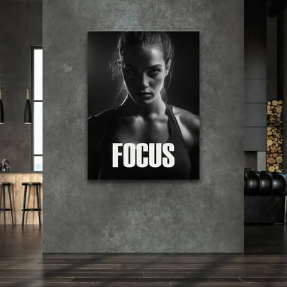 Minimalist fitness wall art of a determined woman in dramatic overhead lighting.