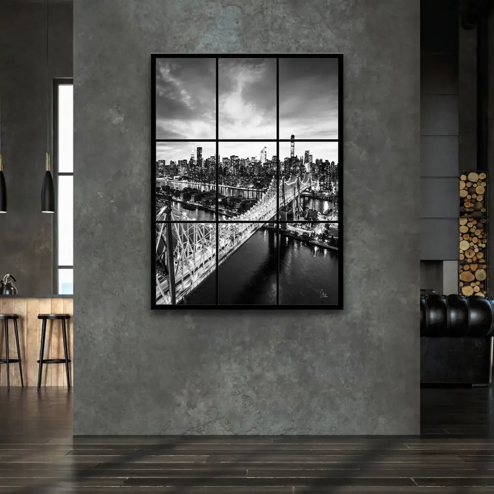 Iconic Queensboro Bridge lit up over the urban skyline in black and white.