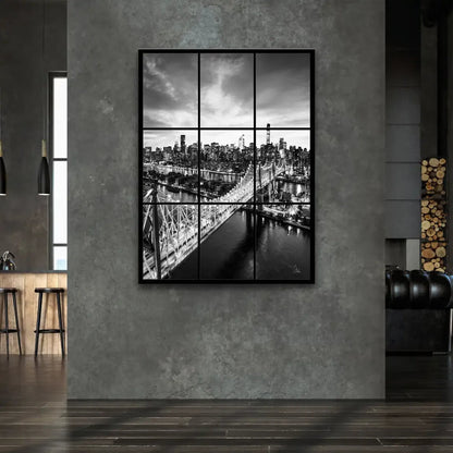 Iconic Queensboro Bridge lit up over the urban skyline in black and white.