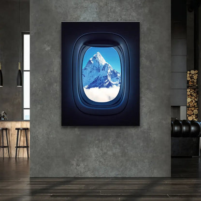 Snow-capped Everest peak against deep blue sky and clouds