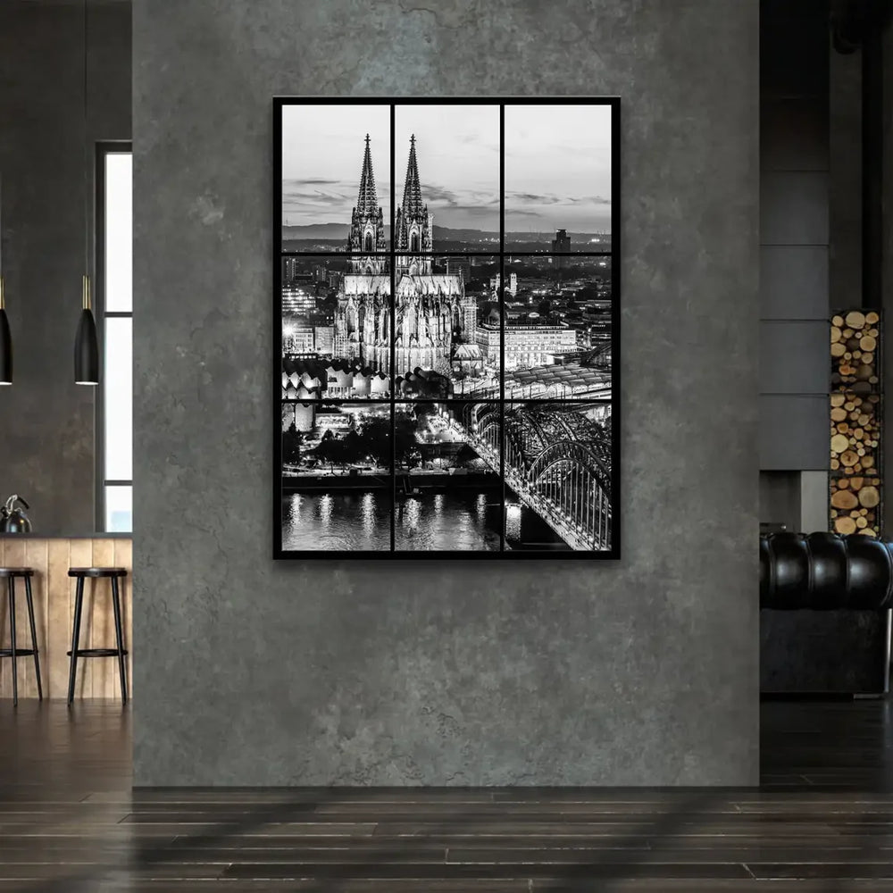 Illuminated Gothic spires of Cologne Cathedral reach into a dramatic, cloud-streaked sky.