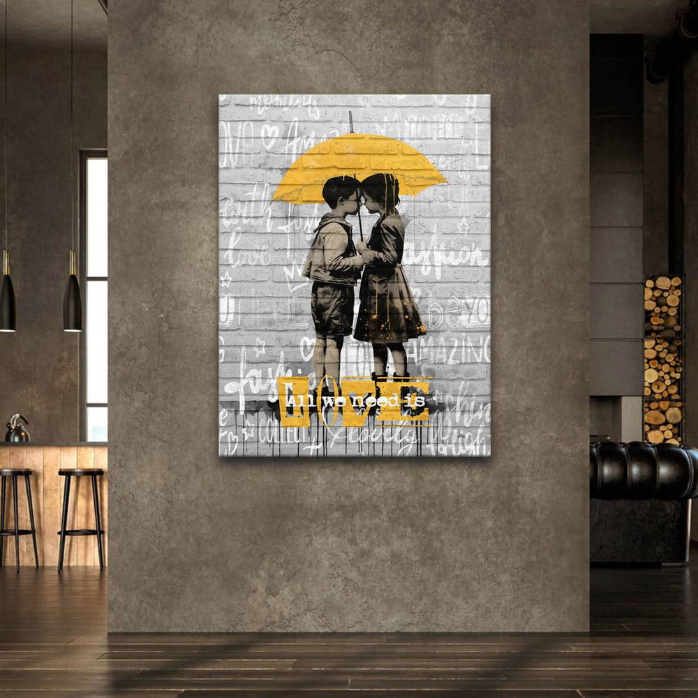 Close-up of the two children leaning in for a kiss under the umbrella in black and white