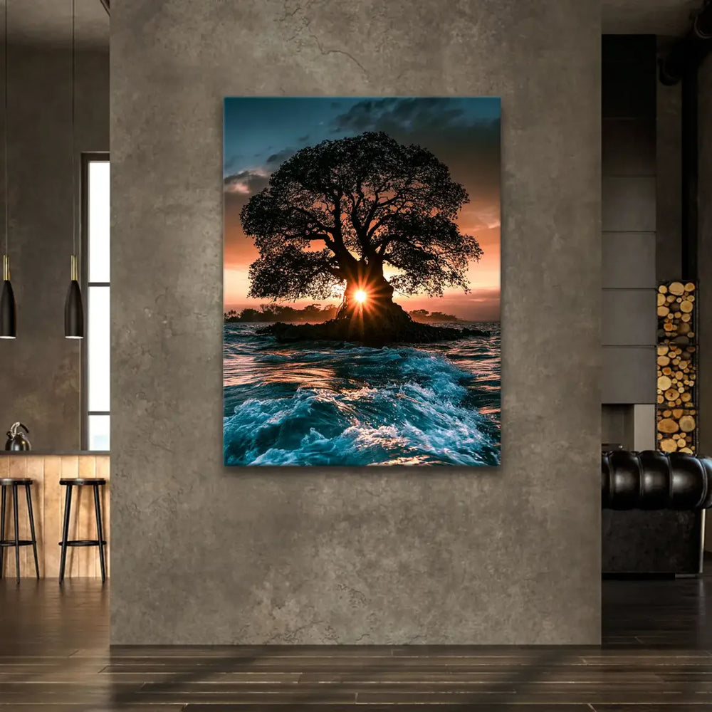 Ocean surface reflecting sunset colors beneath the tree