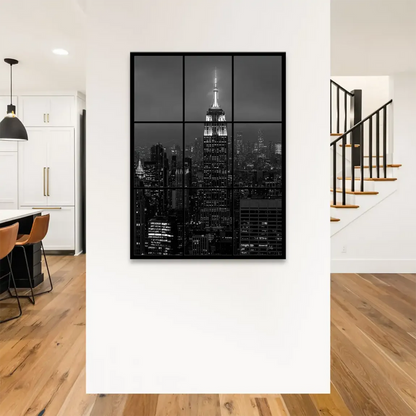 Monochrome canvas wall art highlighting the lit Empire State Building against a cloudy night sky.