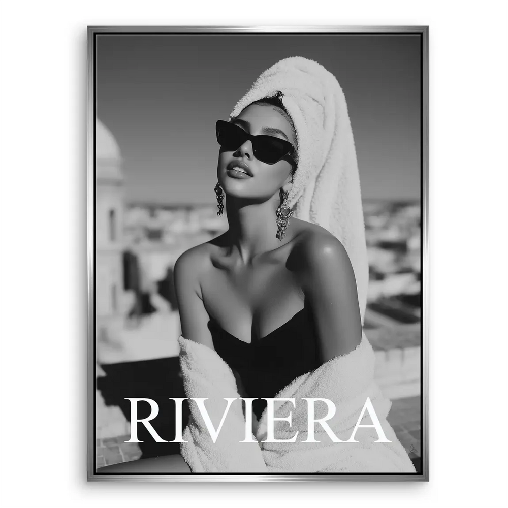 Cityscape blur behind a bold Riviera wordmark on a canvas print.