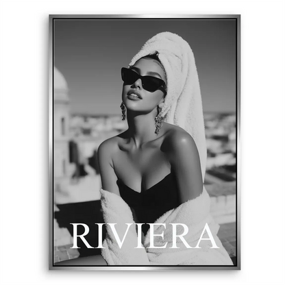 Cityscape blur behind a bold Riviera wordmark on a canvas print.