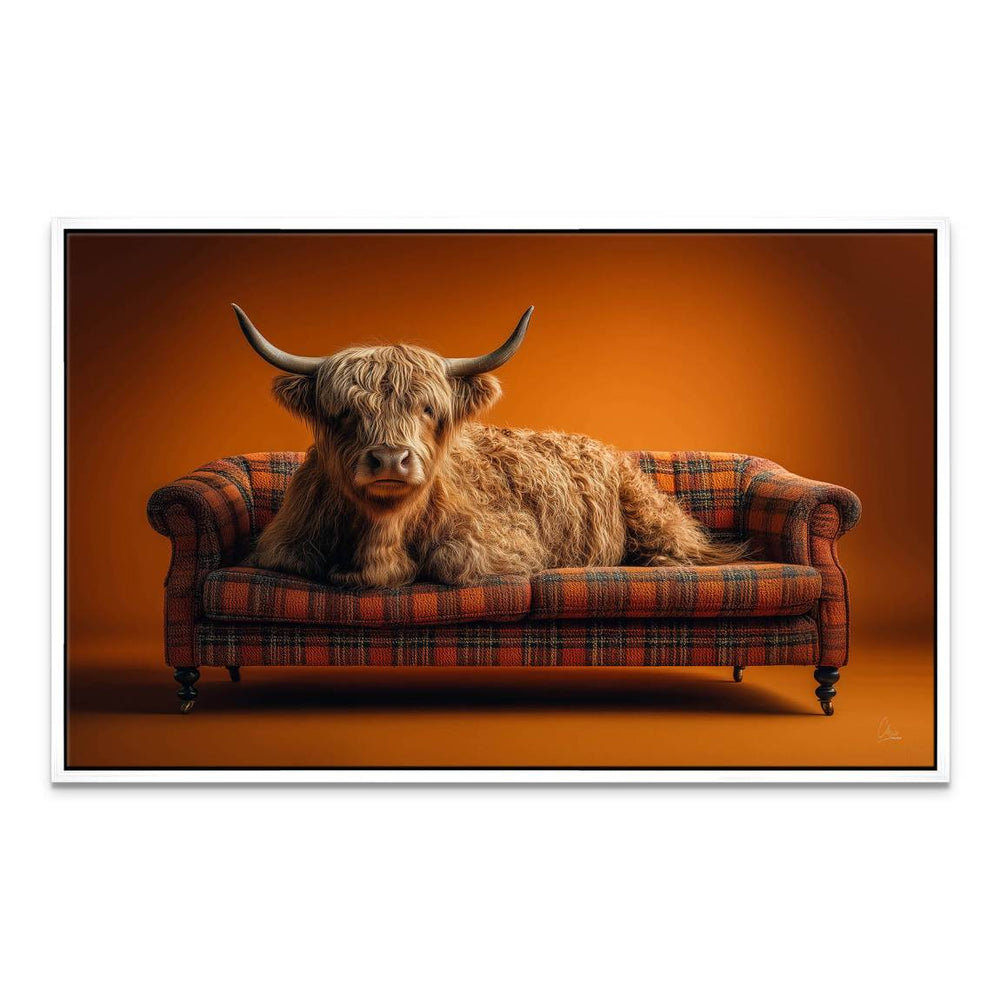 Rustic Scottish-inspired wall art with Highland cow and orange plaid upholstery.